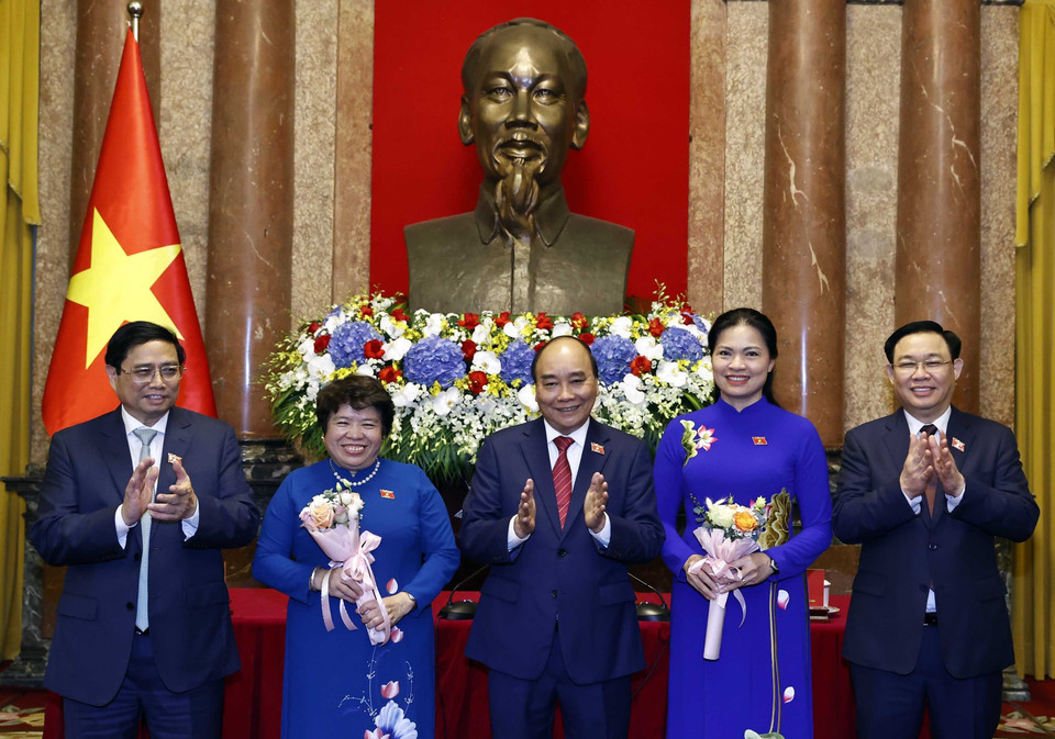 Chủ tịch nước Nguyễn Xuân Phúc, Thủ tướng Chính phủ Phạm Minh Chính, Chủ tịch Quốc hội Vương Đình Huệ tặng hoa cho đại biểu Hà Thị Nga, Chủ tịch Hội Liên hiệp Phụ nữ Việt Nam và đại biểu Nguyễn Thuý Anh, Chủ tịch Nhóm nữ đại biểu Quốc hội khoá XV. (Ảnh: Thống Nhất/TTXVN)