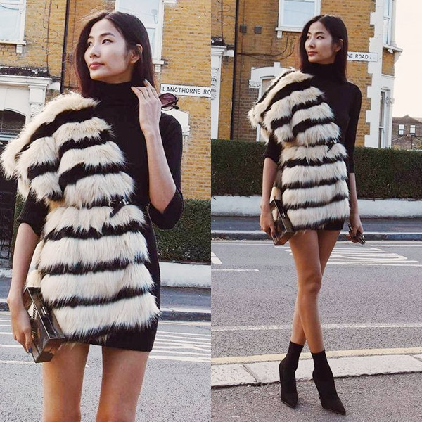 Hoàng Thùy nổi bật trên đường phố Anh với đầm đen cổ cao phối cùng khăn choàng lông sành điệu. Trong thời gian đi diễn tại Anh, chân dài còn tranh thủ 'nâng cấp' phong cách bắt kịp xu hướng thế giới.