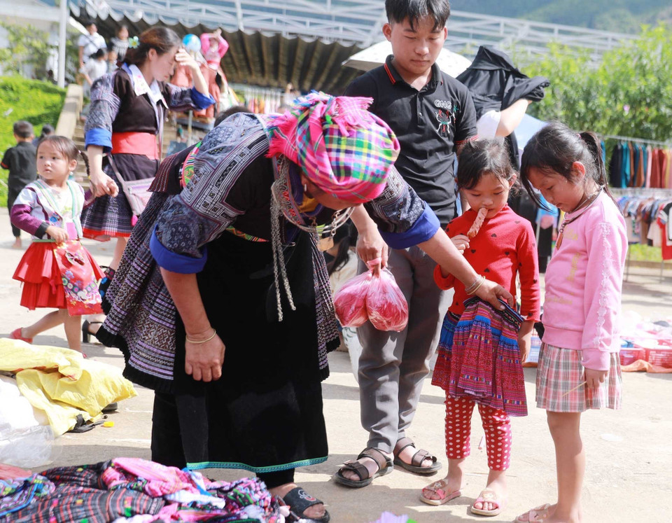 Chợ phiên không chỉ dành cho người lớn mà còn là niềm vui của những đứa trẻ khi được đến chợ, được mẹ mua cho quần áo mới. (Ảnh: Quý Trung/TTXVN)