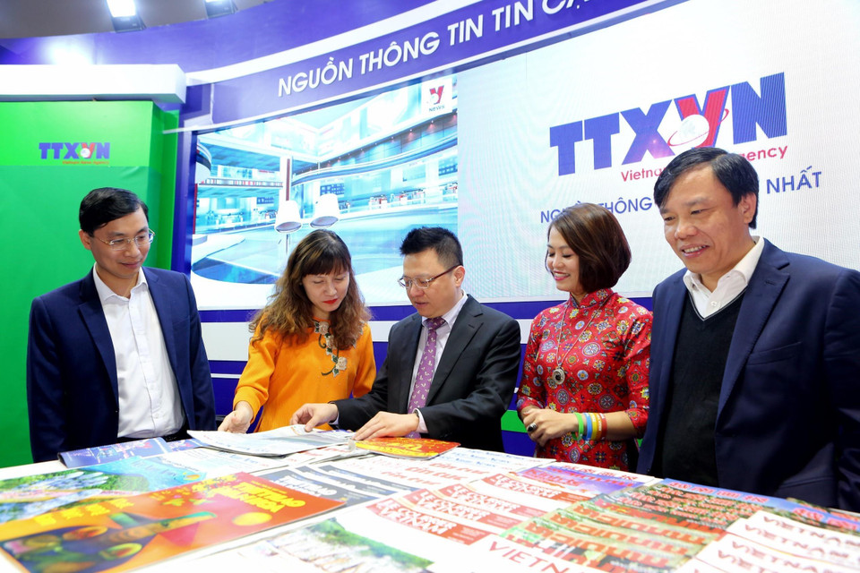 Phó Tổng Giám đốc TTXVN Lê Quốc Minh và các cán bộ, phóng viên, biên tập viên tại gian trưng bày của Thông tấn xã Việt Nam. (Ảnh: Thành Đạt/TTXVN)