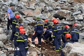 Hàng trăm cán bộ, chiến sỹ công an, quân đội cùng các phương tiện chuyên dụng được huy động để tìm kiếm hai nạn nhân bị vùi lấp. (Ảnh: TTXVN phát)