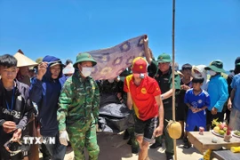 Thi thể nạn nhân M.V.L. đã được đưa vào bờ làm thủ tục để bàn giao cho gia đình mai táng theo phong tục của địa phương. (Ảnh: TTXVN phát)