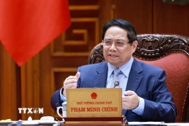 Thủ tướng Phạm Minh Chính chủ trì cuộc họp về triển khai đẩy nhanh tiến độ thực hiện các dự án đường sắt kết nối Việt-Trung. (Ảnh: Dương Giang/TTXVN)