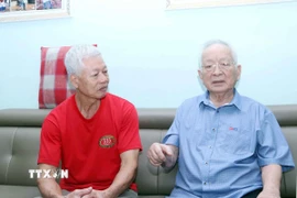 Cụ Biện Văn Bành (phải) chia sẻ quá trình tham gia cách mạng của mình với ông Chu Văn Phái, Chủ tịch Chi hội Cựu chiến binh khu phố 17, phường Tân Bình. (Ảnh: Xuân Khu/TTXVN)