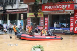 Lực lượng chức năng tỉnh Cao Bằng hỗ trợ người dân di chuyển tài sản trong bão lũ. (Ảnh: Chu Hiệu/TTXVN)