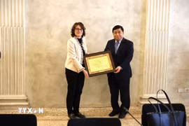 Phó Thủ tướng Nguyễn Chí Dũng tặng quà lưu niệm lãnh đạo ngân hàng Intesa Sanpaolo. (Ảnh: Hải Đăng/TTXVN)