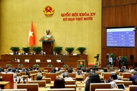 Quốc hội biểu quyết thông qua Luật Dân số. (Ảnh: Doãn Tấn/TTXVN)