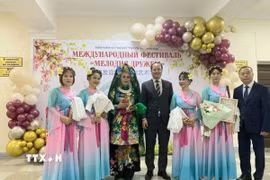 Nhóm nghệ thuật của cộng đồng người Việt Nam và Tổng lãnh sự Nguyễn Việt Kiên (đứng giữa) chụp ảnh lưu niệm. (Ảnh: TTXVN phát)