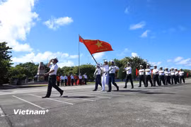 Đi đầu là đội danh dự với Quân kỳ Quyết thắng qua lễ đài trước cờ Tổ quốc và cột mốc chủ quyền đảo Trường Sa. (Ảnh: Huy Khánh/Vietnam+)