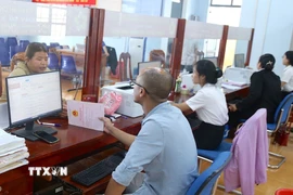 Người dân đến làm các thủ tục hành chính trong ngày 1/7 tại Trung tâm phục vụ hành chính công xã Đức Cơ, tỉnh Gia Lai. (Ảnh: Quang Thái/TTXVN)