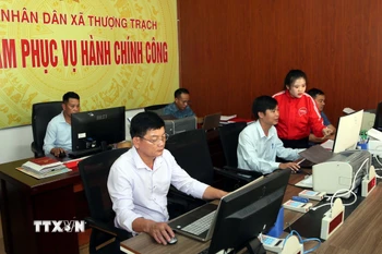 Cán bộ Trung tâm hành chính công xã Thượng Trạch (Quảng Trị) nỗ lực cố gắng để chuyển đổi số, xây dựng chính quyền điện tử. (Ảnh: Tá Chuyên/TTXVN)