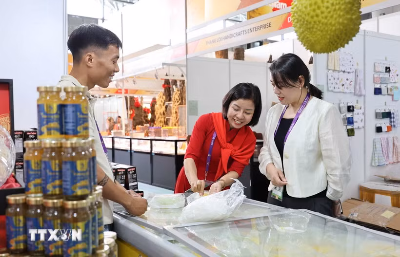 Đại diện doanh nghiệp Việt Nam giới thiệu sản phẩm bánh sầu riêng cho khách Trung Quốc. (Ảnh: Công Tuyên/TTXVN)
