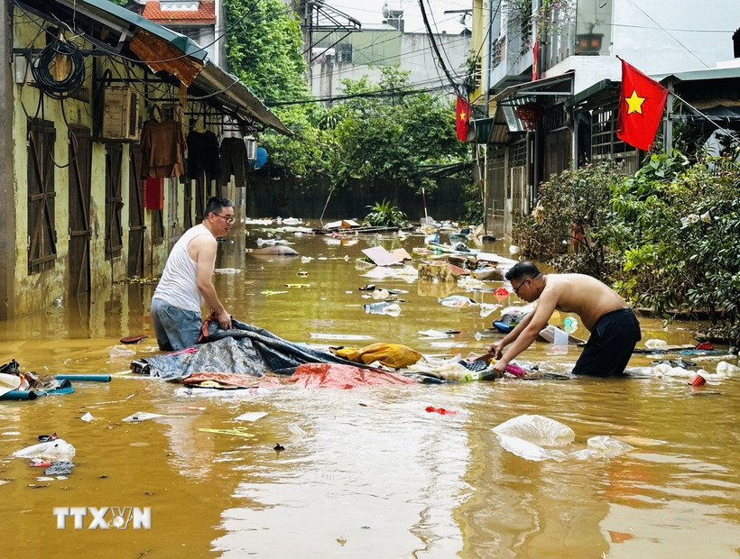 Người dân dọn dẹp nhà cửa sau trận lụt ở phường Hà Giang 1 (Tuyên Quang). (Ảnh: Đức Thọ/TTXVN)