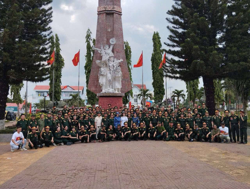 Đoàn cựu chiến binh phía Bắc chụp ảnh kỷ niệm tại Đài tưởng niệm Đăk Tô. (Nguồn: Vietnam+)