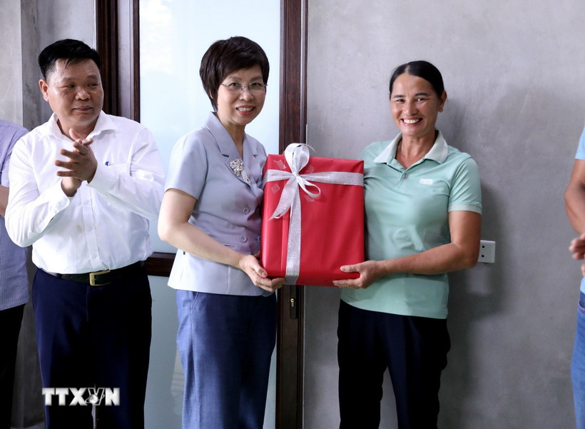 Tổng Giám đốc TTXVN Vũ Việt Trang tặng quà cho gia đình được TTXVN hỗ trợ xây dựng nhà mới. (Ảnh: Quang Cường/TTXVN)