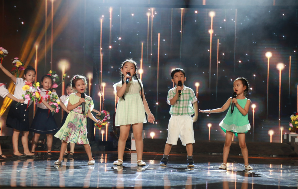 Bốn thí sinh nhí của đội Rê đã có màn ‘chào sân’ khá ấn tượng với tiết mục ‘Em bay trong đêm pháo hoa’ lung linh sắc màu. (Ảnh: BTC)