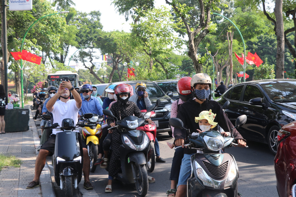Tại khu vực Hồ Tây, một lượng người tham gia giao thông lớn đổ về gây nghẽn gần như toàn bộ tuyến đường Thanh Niên. Nhiều phương tiện đi lên vỉa hè cũng gặp khó khăn vì người dân đổ về đây thư giãn, hóng mát cũng nhiều không kém. (Ảnh: Minh Anh/Vietnam+)
