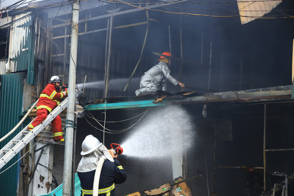 Người dân cho hay ngọn lửa xuất phát từ xưởng làm nội thất, sau đó lan sang các xưởng khác. (Ảnh: PV/Vietnam+)