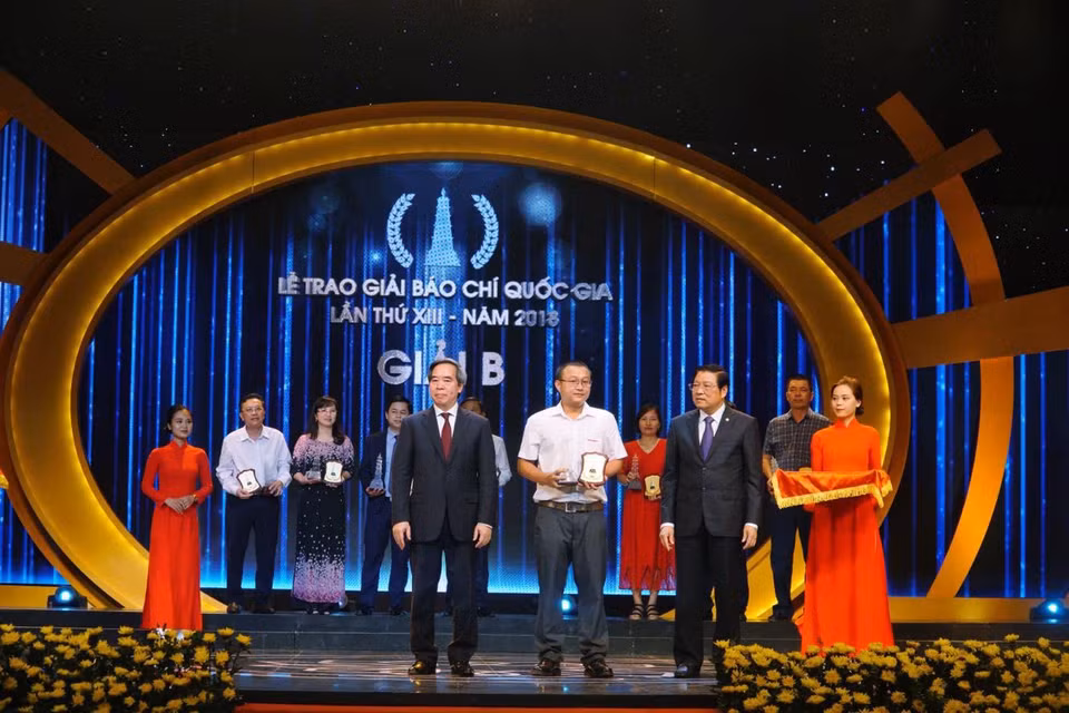 Phóng viên Trần Sơn Bách - đại diện nhóm tác giả loạt bài 'Họ hy sinh cho nước bạn hồi sinh' nhận giải B. (Ảnh: Minh Hiếu/Vietnam+)