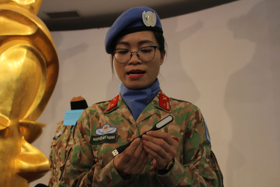 Chiếc đèn sạc mà Thiếu tá Nguyễn Mỹ Hạnh (Trợ lý phòng Công tác Địa bàn, Cục Gìn giữ Hòa bình Việt Nam) đang cầm chính là vật kỷ niệm mà chị được Trung tá Đỗ Anh để lại. Chia sẻ tại buổi tiếp nhận, Thiếu tá Mỹ Hạnh cho biết bản thân từng đắn đo rất nhiều vì muốn giữ lại chiếc đèn cho bản thân, về sau mới đồng thuận để trao lại hiện vật cho bảo tàng. (Ảnh: Minh Anh/Vietnam+)
