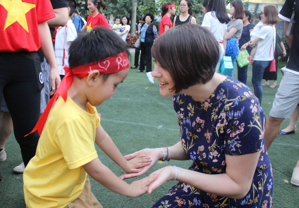 Nhưng vẫn không quên chạy lại nhờ mẹ tiếp sức. (Ảnh: PV/Vietnam+)