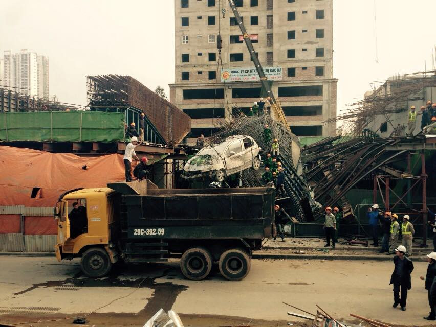 Bắt đầu đưa chiếc taxi lên thùng xe tải (Ảnh: Sơn Bách-Võ Phương/Vietnam+)