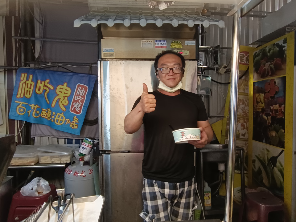 Một chủ cửa hàng tranh thủ ăn vội bữa tối. (Ảnh: PV/Vietnam+)