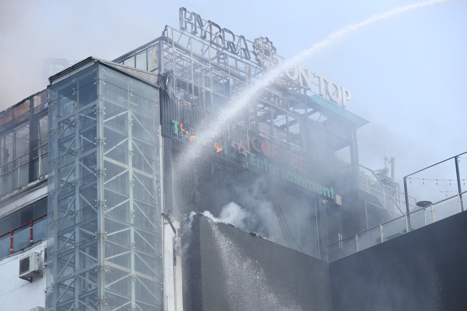 Lực lượng cứu hỏa phun nước dập đám cháy. (Ảnh: Hoài Nam/Vietnam+)