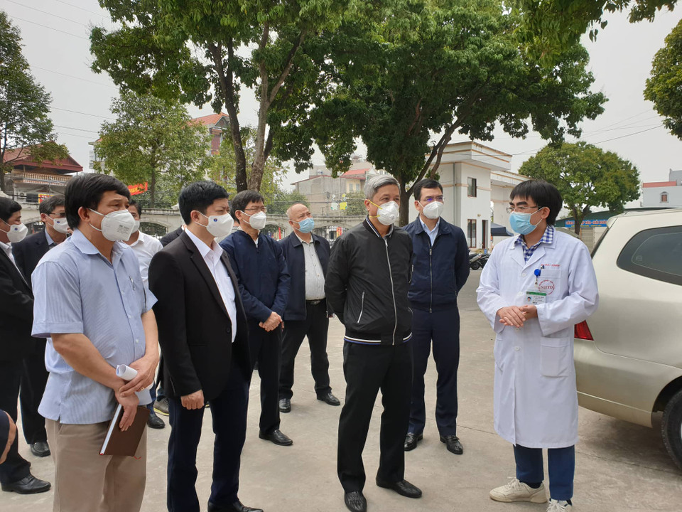 Thứ trưởng Bộ Y tế Nguyễn Trường Sơn nghe các bác sỹ tại Bệnh viện dã chiến số 1 báo cáo về công tác điều trị cho bệnh nhân. (Ảnh: T.G/Vietnam+)
