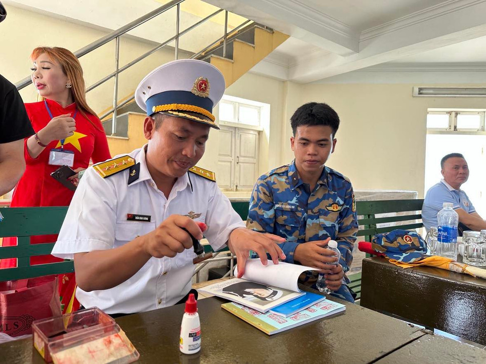 Cán bộ tại Đảo Len Đao đóng dấu cho nhiều người dân. (Ảnh: T.G/Vietnam+)