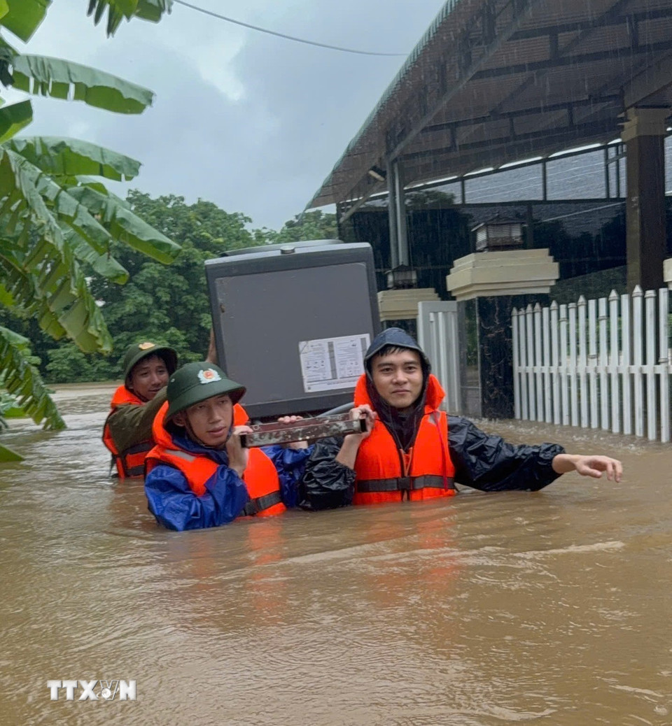 Di dời tài sản của người dân đến nơi an toàn. (Ảnh: TTXVN phát)