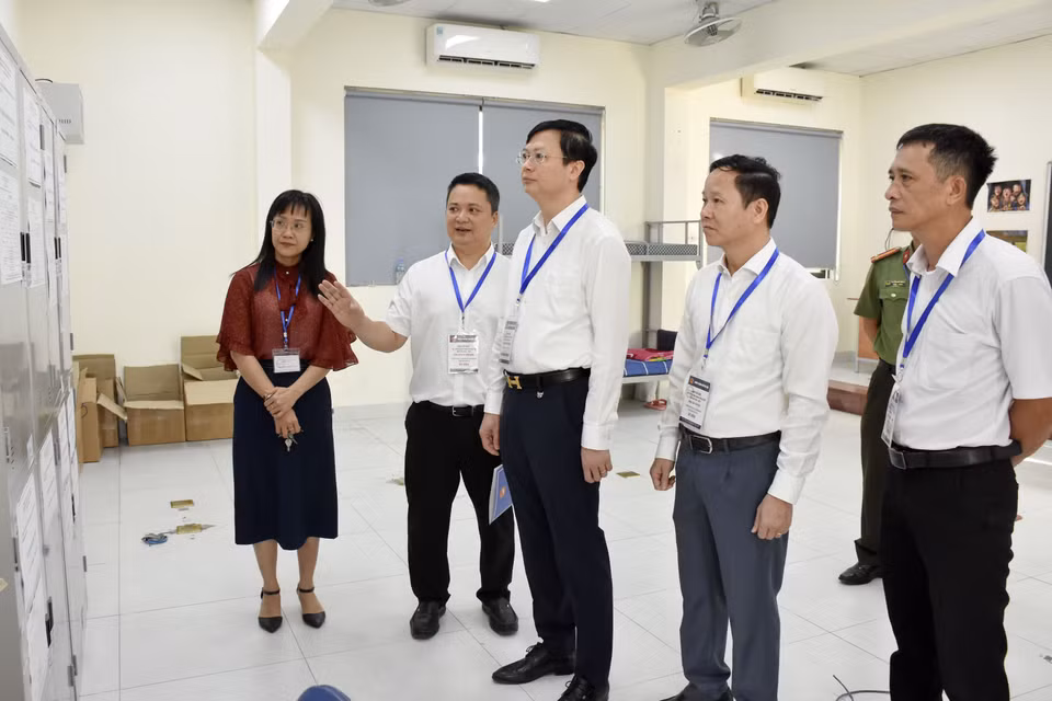Giám đốc Sở Giáo dục và Đào tạo Hà Nội Nguyễn Văn Hiền (thứ ba từ trái qua) và đoàn công tác kiểm tra công tác tổ chức thi tại điểm thi. (Ảnh: Nguyễn Cúc/TTXVN)