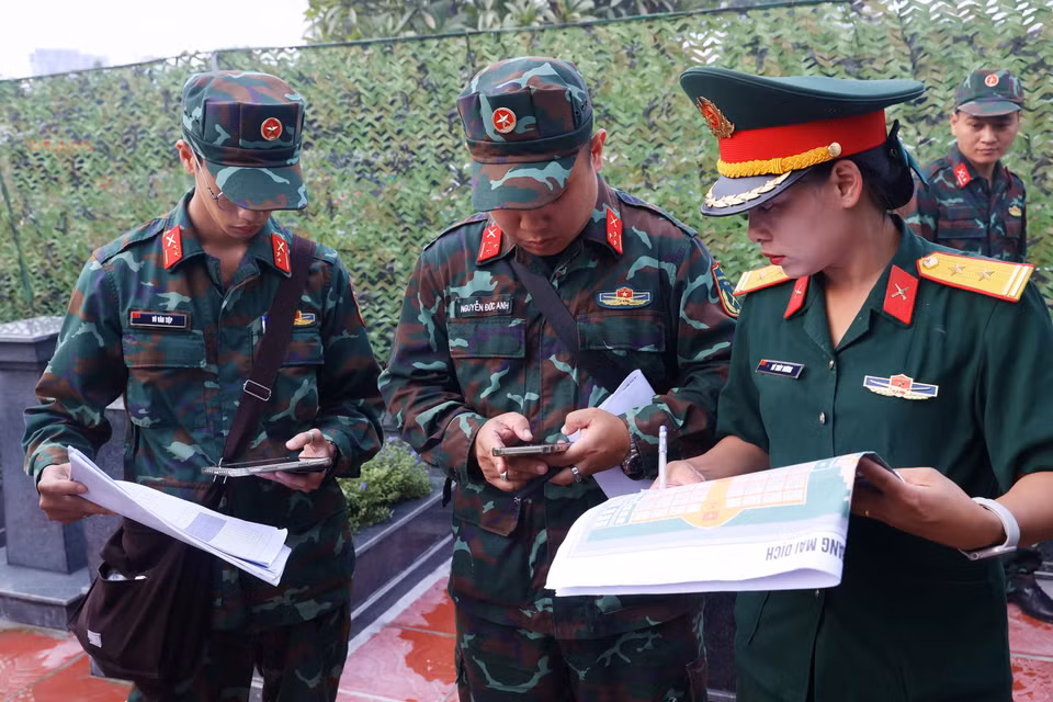 Thực hiện quy trình số hóa dữ liệu thông tin về vị trí, tọa độ mộ liệt sỹ tại Nghĩa trang Mai Dịch (phường Phú Diễn). (Ảnh: Văn Điệp/TTXVN)