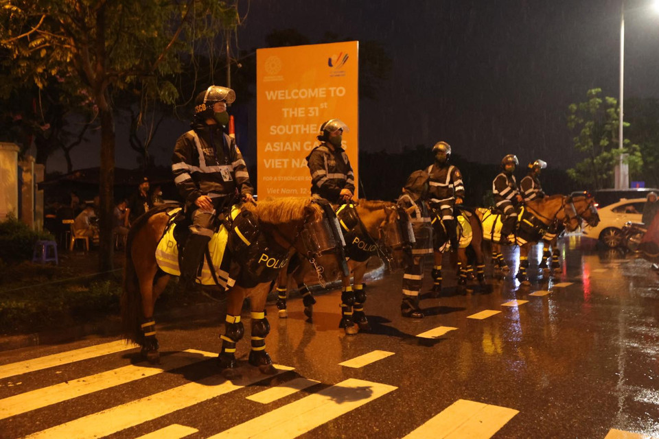 Đội kỵ binh đứng dầm mưa bảo vệ khu vực bên ngoài địa điểm diễn ra Lễ bế mạc SEA Games 31. (Ảnh: Minh Hiếu/Vietnam+)