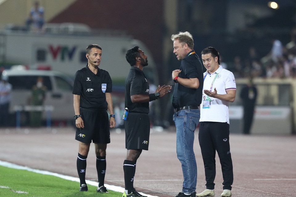 Trọng tài Adam Fazeel nhắc nhở HLV trưởng U23 Thái Lan Mano Polking vì không thực hiện quy định mặc áo bib. (Ảnh: Hoàng Linh/TTXVN)