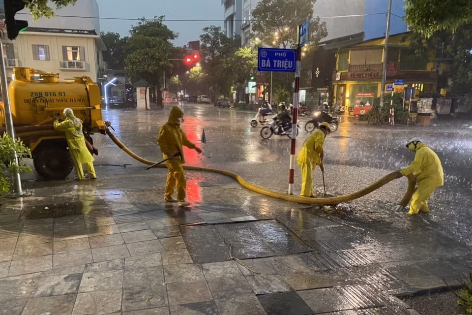 Công nhân Công ty Thoát nước Hà Nội triển khai các biện pháp chống ngập tại ngã 5 Bà Triệu - Nguyễn Du - Hồ Xuân Hương. (Ảnh: Mạnh Khánh/TTXVN)