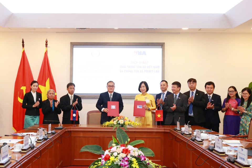 Tổng giám đốc Thông tấn xã Việt Nam Vũ Việt Trang và Tổng giám đốc Thông tấn xã Pathet Lào Khampheuy Philapha trao Biên bản ghi nhớ hợp tác. (Ảnh: Phương Hoa/TTXVN)