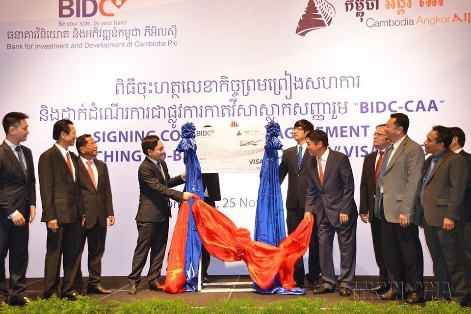 Chiều 25/11/2014, tại Phnom Penh, Ngân hàng Đầu tư Phát triển Campuchia (BIDC) - Công ty con của Ngân hàng Đầu tư phát triển Việt Nam (BIDV) và Công ty Hàng không Quốc gia Campuchia – Cambodia Angkor Air (Công ty liên doanh giữa Tổng công ty Hàng không Việt Nam - Vietnam Airlines và Chính phủ Campuchia) ký kết hợp đồng hợp tác cung cấp dịch vụ thẻ tín dụng Visa Card BIDC-CAA. (Ảnh: Xuân Khu/TTXVN)