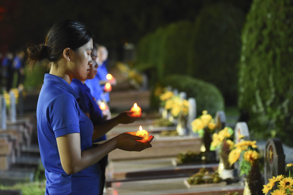 Hàng trăm đoàn viên thanh niên thắp nến tri ân lên các phần mộ liệt sỹ tại Nghĩa trang A1-Điện Biên. (Ảnh: Xuân Tư/TTXVN)