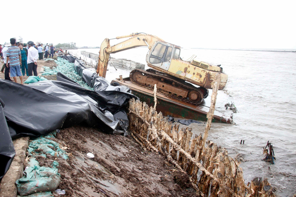 Một đoạn kè bị sóng đánh tan hoang. (Ảnh: Huỳnh Thế Anh/TTXVN)