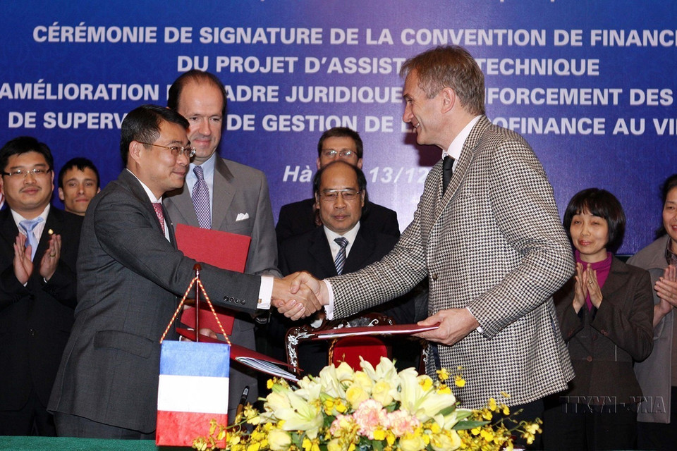Đại diện Ngân hàng Nhà nước Việt Nam, Cơ quan Phát triển Pháp (AFD) và Đại sứ quán Pháp ký kết khoản viện trợ không hoàn lại trị giá 1 triệu Euro của Pháp giúp Việt Nam thực hiện dự án hỗ trợ kỹ thuật “Hoàn thiện khuôn khổ pháp lý và tăng cường năng lực quản lý, giám sát cho lĩnh vực tài chính vi mô tại Việt Nam (Hà Nội, 13/12/2011). (Ảnh: Trần Việt/TTXVN)