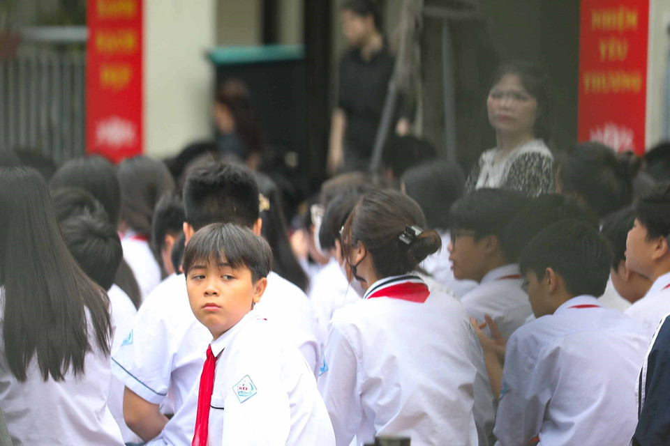 Học sinh trường Trung học Cơ sở Khương Đình chưa hết bàng hoàng trước sự ra đi đột ngột của các bạn học sinh cùng trường trong vụ cháy chung cư mini tại phố Khương Hạ (Thanh Xuân, Hà Nội). (Ảnh: Thanh Tùng/TTXVN)
