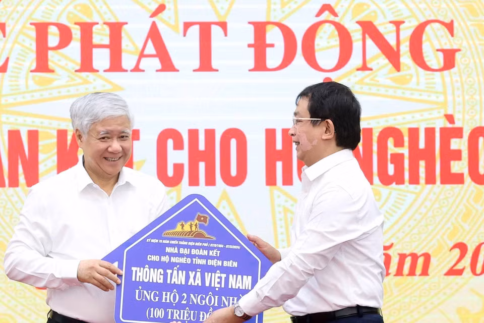 Phó Tổng Giám đốc Thông tấn xã Việt Nam Nguyễn Tuấn Hùng trao ủng hộ làm nhà Đại đoàn kết cho hộ nghèo của tỉnh Điện Biên. (Ảnh: Thống Nhất/TTXVN)