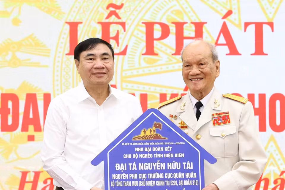 Đại tá Nguyễn Hữu Tài trao ủng hộ làm nhà Đại đoàn kết cho hộ nghèo tỉnh Điện Biên. (Ảnh: Thống Nhất/TTXVN)