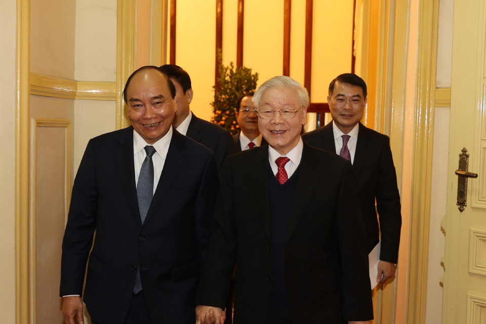 Tổng Bí thư, Chủ tịch nước Nguyễn Phú Trọng và Thủ tướng Nguyễn Xuân Phúc đến dự buổi chúc Tết. (Ảnh: Trí Dũng/TTXVN)