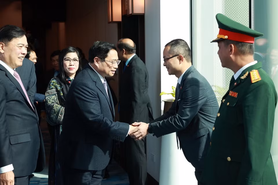 Cán bộ, nhân viên Đại sứ quán và cộng đồng người Việt Nam đón Thủ tướng Phạm Minh Chính và Phu nhân tại sân bay Changi. (Ảnh: Dương Giang/TTXVN)