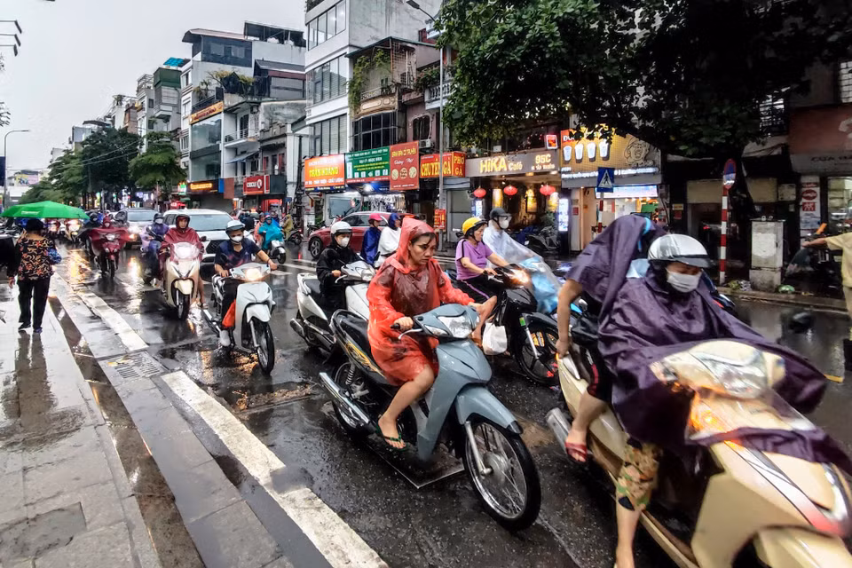 Tại khu vực phố Khâm Thiên, người dân di chuyển chậm do ảnh hưởng của mưa lớn. (Ảnh: Hoài Nam/Vietnam+)