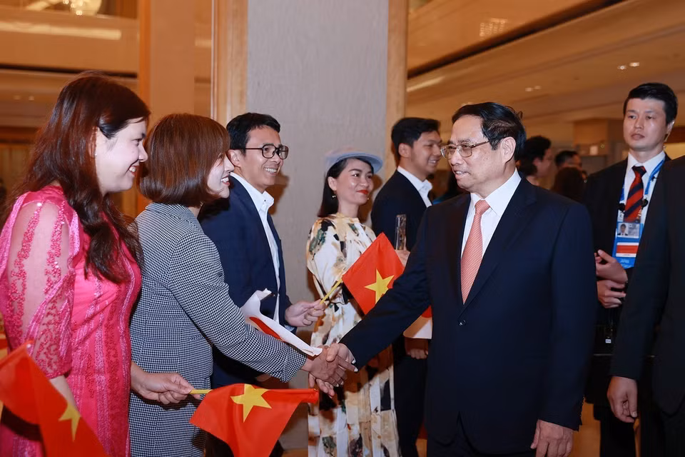 Cán bộ, nhân viên Đại sứ quán và cộng đồng người Việt Nam tại Nhật Bản đón Thủ tướng Phạm Minh Chính. (Ảnh: Dương Giang/TTXVN)