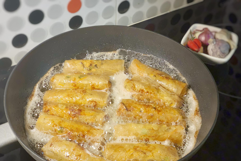 Cho dầu ăn vào chảo và rán nem vàng từng mặt. Với loại vỏ bánh đa nem này nem rán xong có thể giữ được lớp vỏ giòn rụm trong khoảng 1 tiếng. (Ảnh: Mai Mai/Vietnam+)