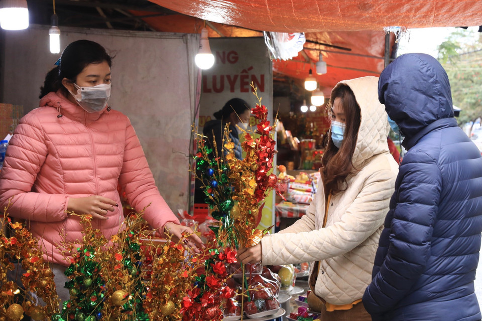 Mua đồ lễ trước khi vào cúng tại Phủ Tây Hồ ngày 13 tháng Giêng năm Nhâm Dần. (Ảnh: Hoàng Hiếu/TTXVN)